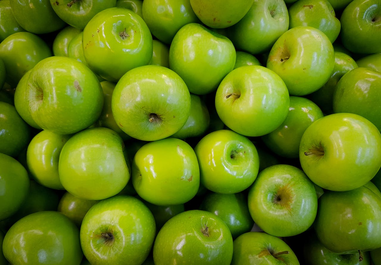 A vibrant close-up of shiny green apples showcasing freshness and abundance.